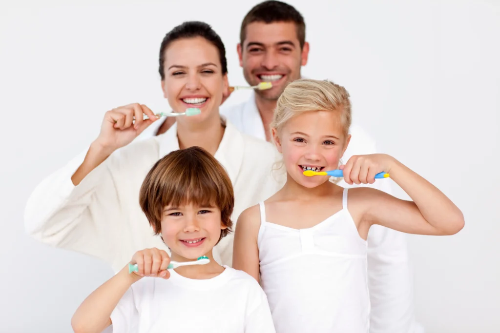 family cleaning their teeth bathroom